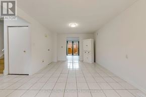 Hamilton (Beasley) townhouse for rent - A spacious white room with a tiled floor and a refrigerator.