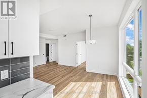 Ottawa multi-family for rent - A real estate company's logo is displayed on a wall in a modern, empty living space.