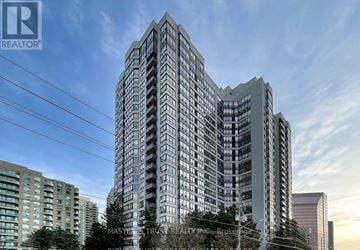 Toronto (Newtonbrook East) condo for rent - A tall building with many windows is the main focus of the image.