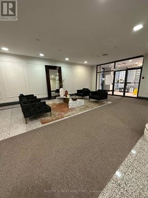 Toronto (Newtonbrook East) condo for rent - A waiting area with a carpet and chairs.