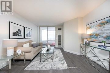 Toronto (Newtonbrook East) condo for rent - A living room with a glass table and a couch.