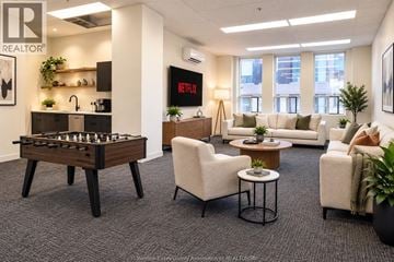 Windsor condo for rent - A living room with a foosball table and a couch.