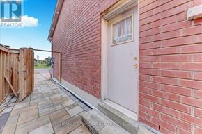 Markham (Middlefield) apartment for rent - A red brick house with a white door and a wooden fence.