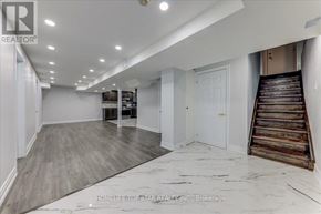 Markham (Middlefield) apartment for rent - A spacious room with a wooden staircase on the right side.