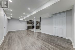 Markham (Middlefield) apartment for rent - A spacious room with a white door and a wooden floor.