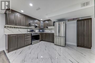 Markham (Middlefield) apartment for rent - A modern kitchen with dark wood cabinets and marble flooring.