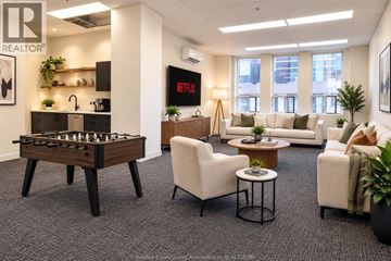 Windsor condo for rent - A living room with a foosball table and a couch.