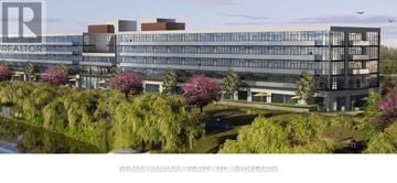 Welland (Broadway) condo for rent - A modern building with the word REALTOR on it is surrounded by trees and a body of water.