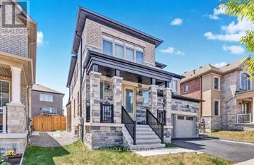 Pickering apartment for rent - A modern two-story house with a stone facade and a black metal staircase.