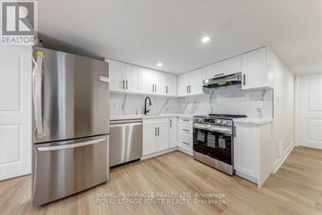 Pickering apartment for rent - A kitchen with white cabinets and stainless steel appliances.