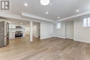 Pickering apartment for rent - A spacious, well-lit kitchen and living room with wooden flooring and white walls.