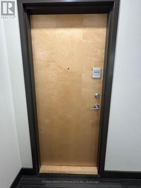 Kitchener condo for rent - A door with a lock and a number plate on it.