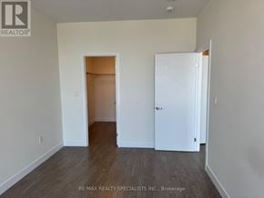 Kitchener condo for rent - A room with a white door and a white closet door.