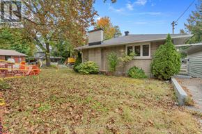 Ottawa apartment for rent - A house with a grey roof and a small garden in front.