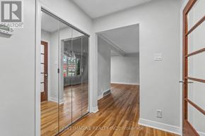 Ottawa apartment for rent - A hallway with a glass door leading to another room.