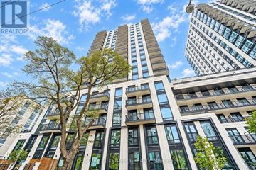 Toronto (Forest Hill South) condo for rent - A kitchen with white cabinets and a wooden island.