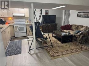 Brampton (Fletcher's West) apartment for rent - A living room with a couch, chair, and television.