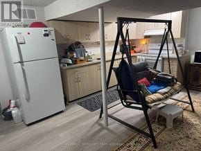 Brampton (Fletcher's West) apartment for rent - A kitchen with a white fridge and a hanging chair.