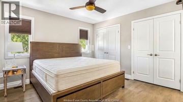 Lasalle apartment for rent - A bedroom with a large bed and a ceiling fan.