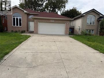 Windsor apartment for rent - A house with a garage in front of it.