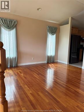 Windsor apartment for rent - A room with wooden floors and curtains on the windows.