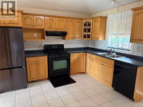 Windsor apartment for rent - A kitchen with wooden cabinets and black appliances.
