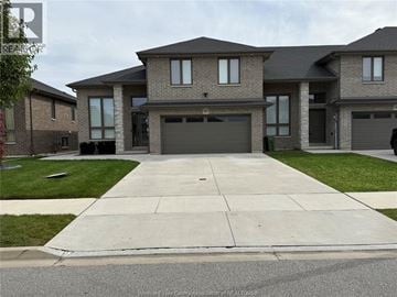 Lakeshore townhouse for rent - A large, modern house with a grey garage door is shown.