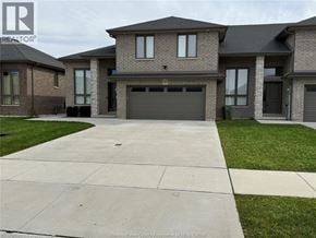 Lakeshore townhouse for rent - A large house with a grey garage door is shown.