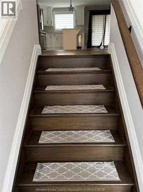 Lakeshore townhouse for rent - A staircase with a carpeted runner and wooden steps.