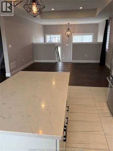 Lakeshore townhouse for rent - A kitchen with a marble counter top and a wooden floor.