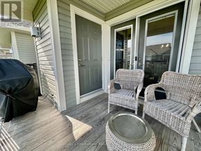Collingwood condo for rent - A patio with a wicker chair and table.