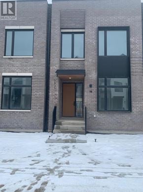 Mississauga (Port Credit) townhouse for rent - A building with a brown door and windows is in front of a snowy ground.