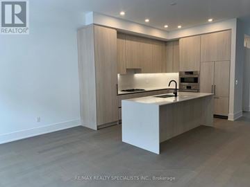 Mississauga (Port Credit) townhouse for rent - A modern kitchen with wooden cabinets and a white island.