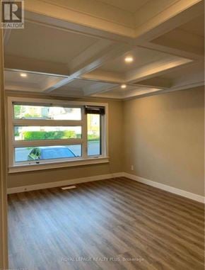Kitchener multi-family for rent - A room with a window and wooden flooring.