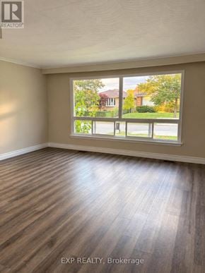 Toronto (Bendale) apartment for rent - A room with wooden flooring and a large window overlooking a street.