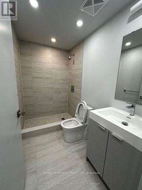 Vaughan (Vaughan Corporate Centre) condo for rent - A bathroom with a toilet, sink, and mirror.