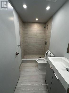 Vaughan (Vaughan Corporate Centre) condo for rent - A bathroom with a toilet, sink, and walk-in shower.