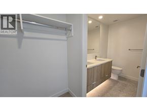 North Vancouver apartment for rent - A bathroom with a toilet, sink, and mirror.