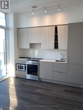 Mississauga (City Centre) condo for rent - A modern kitchen with a stainless steel oven and microwave.
