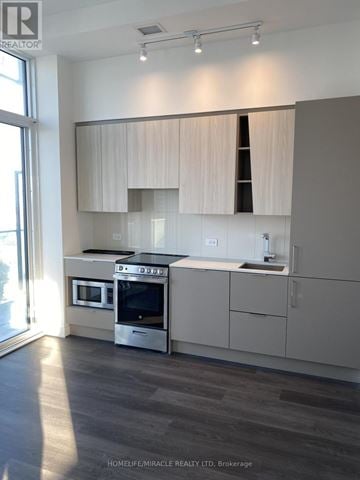 Mississauga (City Centre) condo for rent - A modern kitchen with a stainless steel oven and microwave.