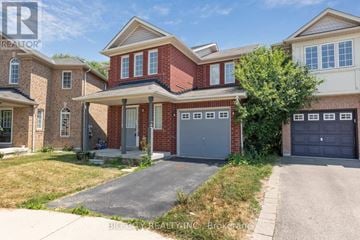 Ajax (South East) apartment for rent - A red brick house with a grey garage door.