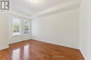 Ajax (South East) apartment for rent - A room with wooden flooring and a window showing trees outside.