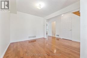 Ajax (South East) apartment for rent - A room with wooden flooring and white walls, with a door on the right side.