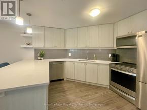 Centre Wellington (Elora/Salem) condo for rent - A kitchen with white cabinets and stainless steel appliances.