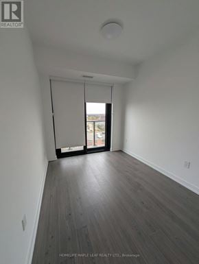 Kitchener condo for rent - A room with a sliding glass door leading to a balcony.