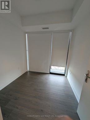 Kitchener condo for rent - A room with wooden flooring and white walls.