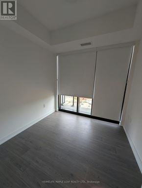 Kitchener condo for rent - A room with a sliding glass door leading to a balcony.