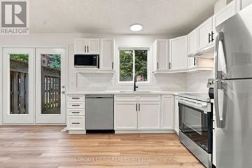 London East (East D) townhouse for rent - A white kitchen with a refrigerator on the right.