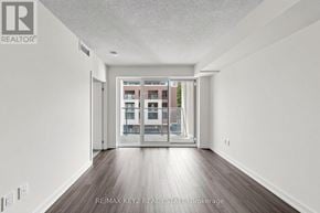 Toronto (Humber Heights) condo for rent - A room with a view of a building through a glass door.
