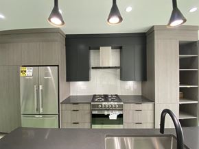 Surrey townhouse for rent - A modern kitchen with a stainless steel sink and a stove top oven.